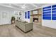 Comfortable living room with a brick fireplace, built-in bookshelves, hardwood floors, and natural light from a window at 1909 Swift Ave, Charleston, SC 29407