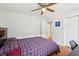 Bedroom features hardwood floors, a ceiling fan, closet, and a bright workspace at 2058 Bishop Dr, Charleston, SC 29414