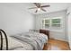 Well-lit bedroom featuring hardwood floors, a ceiling fan, and a window offering natural light at 2058 Bishop Dr, Charleston, SC 29414