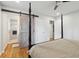 Bedroom with four poster bed, ceiling fan, barn door to bath and a closet at 2058 Bishop Dr, Charleston, SC 29414