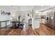 Bright dining room with wood floors, table, chairs, and view into open kitchen at 2058 Bishop Dr, Charleston, SC 29414