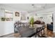 Bright dining room with wood floors, table, chairs, and view into open kitchen and living room at 2058 Bishop Dr, Charleston, SC 29414