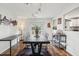 Well-lit dining room featuring modern light fixtures, dark hardwood floors, and access to the kitchen and back yard at 2058 Bishop Dr, Charleston, SC 29414