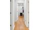 Bright hallway features gleaming hardwood floors leading to a bedroom with a four-poster bed at 2058 Bishop Dr, Charleston, SC 29414