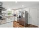 Modern kitchen features stainless steel appliances, granite countertops, and sleek white cabinetry at 2058 Bishop Dr, Charleston, SC 29414