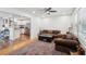Open living area with hardwood floors, a brown leather sofa set, and an adjacent modern kitchen at 2058 Bishop Dr, Charleston, SC 29414