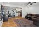 Bright living room with hardwood floors that opens to an open kitchen and dining area at 2058 Bishop Dr, Charleston, SC 29414