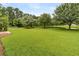 Expansive backyard features a well-maintained lawn and serene pond, providing a beautiful outdoor space at 241 Clayburne Dr, Goose Creek, SC 29445