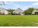 Exterior view of the home's backyard showcasing a well-maintained lawn and the home's architecture at 241 Clayburne Dr, Goose Creek, SC 29445