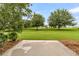 Picturesque backyard featuring a pond view, surrounded by mature trees and a patio at 241 Clayburne Dr, Goose Creek, SC 29445