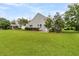 This backyard shows a large green lawn and a home with light gray siding at 241 Clayburne Dr, Goose Creek, SC 29445