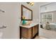 Bathroom with a modern vanity, quartz countertop, a framed mirror, and an open doorway into the bedroom at 241 Clayburne Dr, Goose Creek, SC 29445