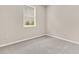 Bright bedroom with neutral walls, a window overlooking the neighborhood, and neutral carpet flooring at 241 Clayburne Dr, Goose Creek, SC 29445