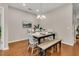 Bright dining room with wood floors, pendant lighting, a rustic table with seating for six, and a decorative centerpiece at 241 Clayburne Dr, Goose Creek, SC 29445