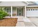 Inviting front porch with stone accents, white columns, and a cozy seating area at 241 Clayburne Dr, Goose Creek, SC 29445
