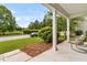 View of the cozy front porch area with chairs overlooking the street and lawn at 241 Clayburne Dr, Goose Creek, SC 29445