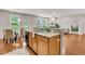 Bright kitchen with granite countertops, stainless steel appliances, and an island with a breakfast bar, flowing into the living room at 241 Clayburne Dr, Goose Creek, SC 29445