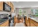Modern kitchen with stainless appliances, granite countertops, wood cabinets, and dining area with a view at 241 Clayburne Dr, Goose Creek, SC 29445