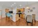 Open kitchen area with black appliances, wood cabinets, a breakfast bar, and adjacent dining space at 241 Clayburne Dr, Goose Creek, SC 29445