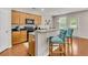 Stylish kitchen with stainless appliances, granite counters, wood cabinets and a breakfast bar at 241 Clayburne Dr, Goose Creek, SC 29445