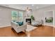 Comfortable living room showcasing wood floors, a fireplace, and bright windows with backyard view at 241 Clayburne Dr, Goose Creek, SC 29445
