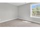 A bright bedroom with carpet floors offers a serene space at 2477 Sawlog Ln, Summerville, SC 29486