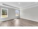 A bright bedroom featuring tray ceiling, base trim, and light colored walls at 2477 Sawlog Ln, Summerville, SC 29486