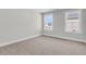 Bright, carpeted bedroom features large windows and neutral walls, creating a serene space at 2477 Sawlog Ln, Summerville, SC 29486