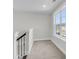 Upstairs hallway with natural light from windows provides views of the neighborhood at 2477 Sawlog Ln, Summerville, SC 29486