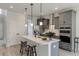 Modern kitchen with stainless steel appliances, an island with seating, and sleek gray cabinetry at 2477 Sawlog Ln, Summerville, SC 29486