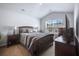 Bright bedroom featuring a large window, neutral carpet, ceiling fan, and modern furnishings at 266 Ivory Shadow Rd, Summerville, SC 29486