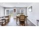 Cozy dining area with a modern table, stylish chairs, and sliding glass doors leading to the backyard at 266 Ivory Shadow Rd, Summerville, SC 29486