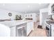 Open-concept kitchen featuring a granite island that offers a view of the stainless steel appliances and living area at 266 Ivory Shadow Rd, Summerville, SC 29486