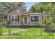 A cozy single-story home with a chain-link fence, grassy front yard, and a charming covered entryway at 2665 Ranger Dr, North Charleston, SC 29405