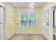 Eat-in kitchen featuring yellow walls, a large window, and built-in shelves for additional storage at 2665 Ranger Dr, North Charleston, SC 29405