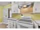 Functional kitchen featuring an oven, yellow backsplash, and classic white cabinetry providing plenty of storage at 2665 Ranger Dr, North Charleston, SC 29405