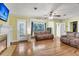 Cozy living room featuring hardwood floors, a fireplace, and large windows offering a sunlit interior at 2665 Ranger Dr, North Charleston, SC 29405