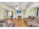 Inviting living room featuring hardwood floors, a fireplace, a ceiling fan and plenty of natural light at 2665 Ranger Dr, North Charleston, SC 29405