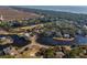 Stunning aerial view of waterfront homes nestled among lush greenery and a tranquil lake, with ocean views in the distance at 287 Driftwood Ln, Edisto Beach, SC 29438
