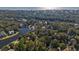 An aerial view shows homes surrounded by trees near a pond and the ocean at 287 Driftwood Ln, Edisto Beach, SC 29438