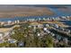 Beautiful aerial view of waterfront homes and a golf course along a serene lake with river and marsh views, creating an idyllic setting at 287 Driftwood Ln, Edisto Beach, SC 29438