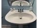 Clean, white pedestal sink in a bathroom with a mirrored wall and soap dispenser at 287 Driftwood Ln, Edisto Beach, SC 29438
