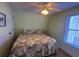 Cozy bedroom features a ceiling fan, window with blinds, and a bed with a tropical-themed comforter at 287 Driftwood Ln, Edisto Beach, SC 29438