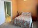 Cozy bedroom featuring floral bedding and ensuite bath with tiled flooring at 287 Driftwood Ln, Edisto Beach, SC 29438