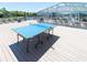 Outdoor game room with a ping pong table and enclosed swimming pool beyond at 287 Driftwood Ln, Edisto Beach, SC 29438