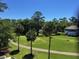 Beautiful green lawn with mature trees surrounds well-maintained homes and manicured walking path at 287 Driftwood Ln, Edisto Beach, SC 29438