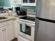 Kitchen with stainless steel appliances and white cabinetry at 287 Driftwood Ln, Edisto Beach, SC 29438