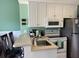 Eat-in kitchen with modern appliances, white cabinets, and sleek countertops at 287 Driftwood Ln, Edisto Beach, SC 29438