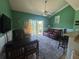 Relaxing living room featuring green walls, ceiling fan, and leather furniture on a vibrant patterned rug at 287 Driftwood Ln, Edisto Beach, SC 29438