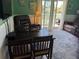 Comfortable living room with dining table, leather furniture, and access to outdoor patio at 287 Driftwood Ln, Edisto Beach, SC 29438